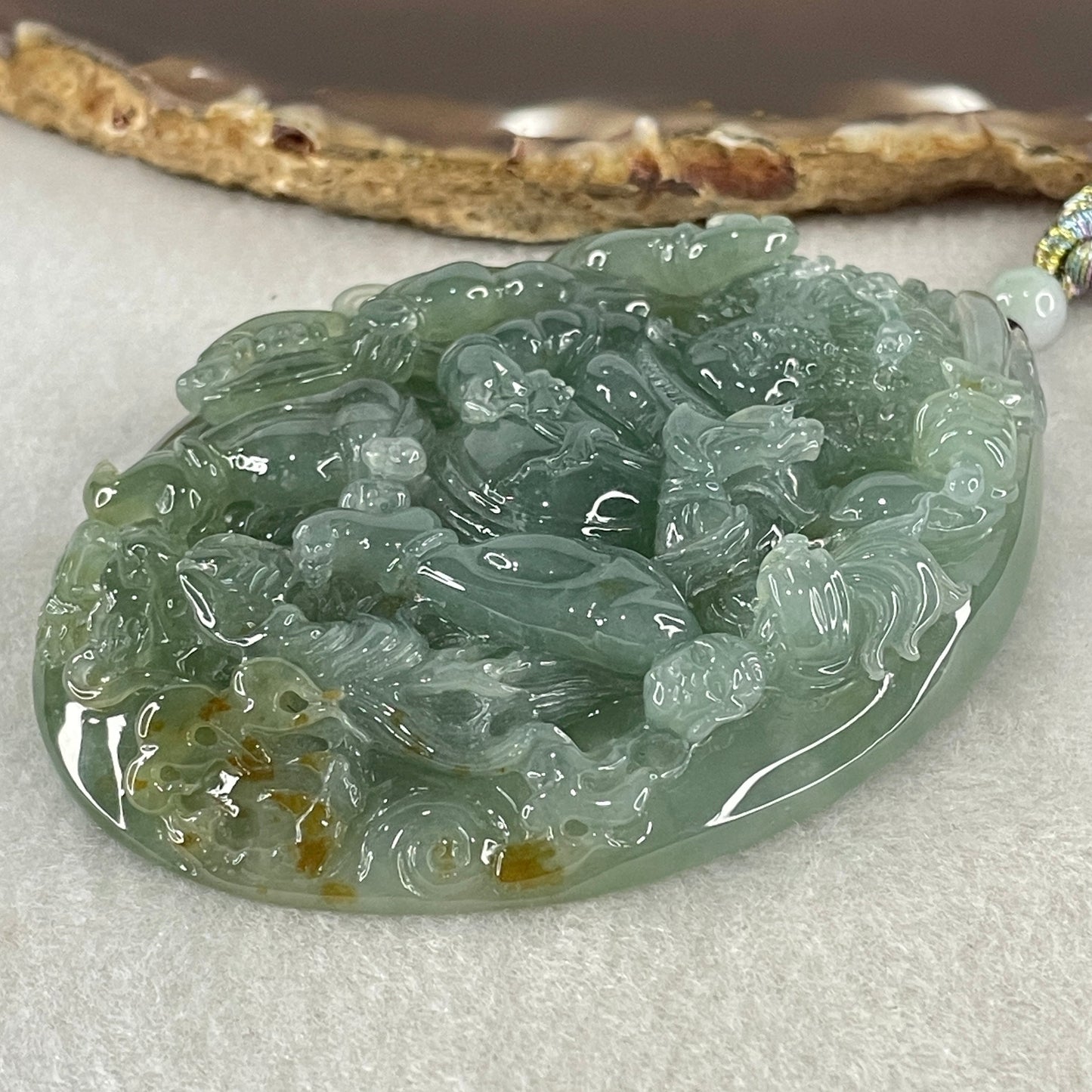 Grand Master Type A Icy Blueish Green with Brown Patches Jadeite Acala Pendant 85.25g 75.0 by 56.6 by 12.4mm
