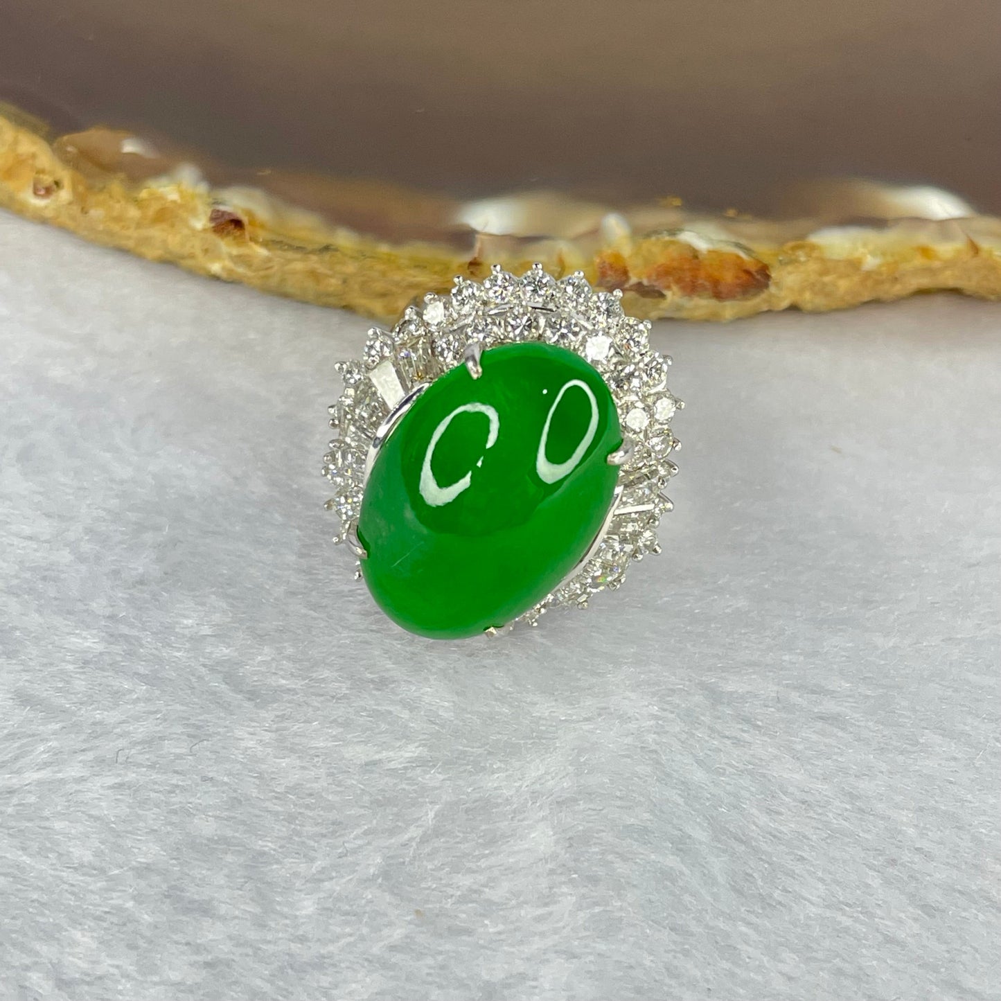 Very Very High Quality Highly Translucent TYPE A Natural Full Intense Green Jadeite Traded as Imperial Green Oval Cabochon Approx. 20.93 by 13.95 by 6.58mm Total Weight 13.60g including Natural Diamonds and 13K White Gold Ring Setting US7.75 HK17 NGI Cert