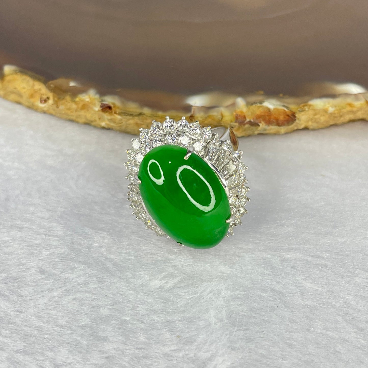 Very Very High Quality Highly Translucent TYPE A Natural Full Intense Green Jadeite Traded as Imperial Green Oval Cabochon Approx. 20.93 by 13.95 by 6.58mm Total Weight 13.60g including Natural Diamonds and 13K White Gold Ring Setting US7.75 HK17 NGI Cert