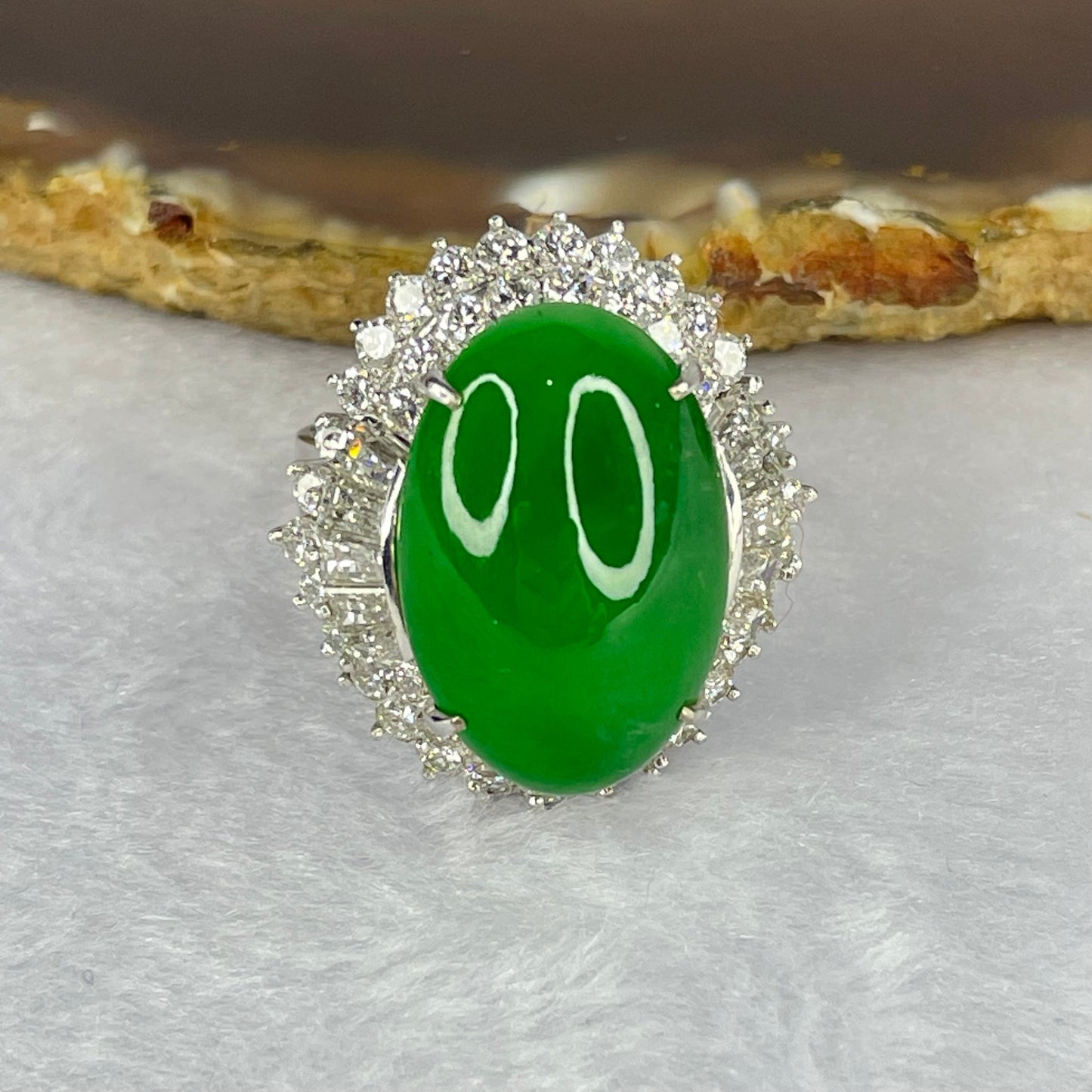 Very Very High Quality Highly Translucent TYPE A Natural Full Intense Green Jadeite Traded as Imperial Green Oval Cabochon Approx. 20.93 by 13.95 by 6.58mm Total Weight 13.60g including Natural Diamonds and 13K White Gold Ring Setting US7.75 HK17 NGI Cert