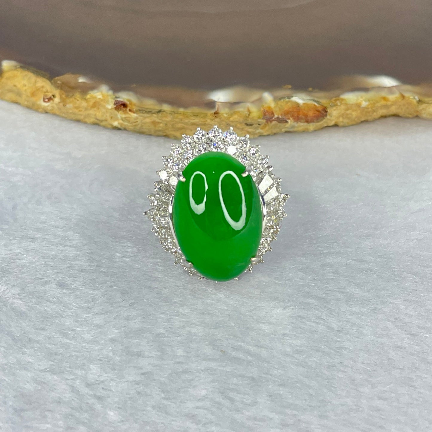 Very Very High Quality Highly Translucent TYPE A Natural Full Intense Green Jadeite Traded as Imperial Green Oval Cabochon Approx. 20.93 by 13.95 by 6.58mm Total Weight 13.60g including Natural Diamonds and 13K White Gold Ring Setting US7.75 HK17 NGI Cert