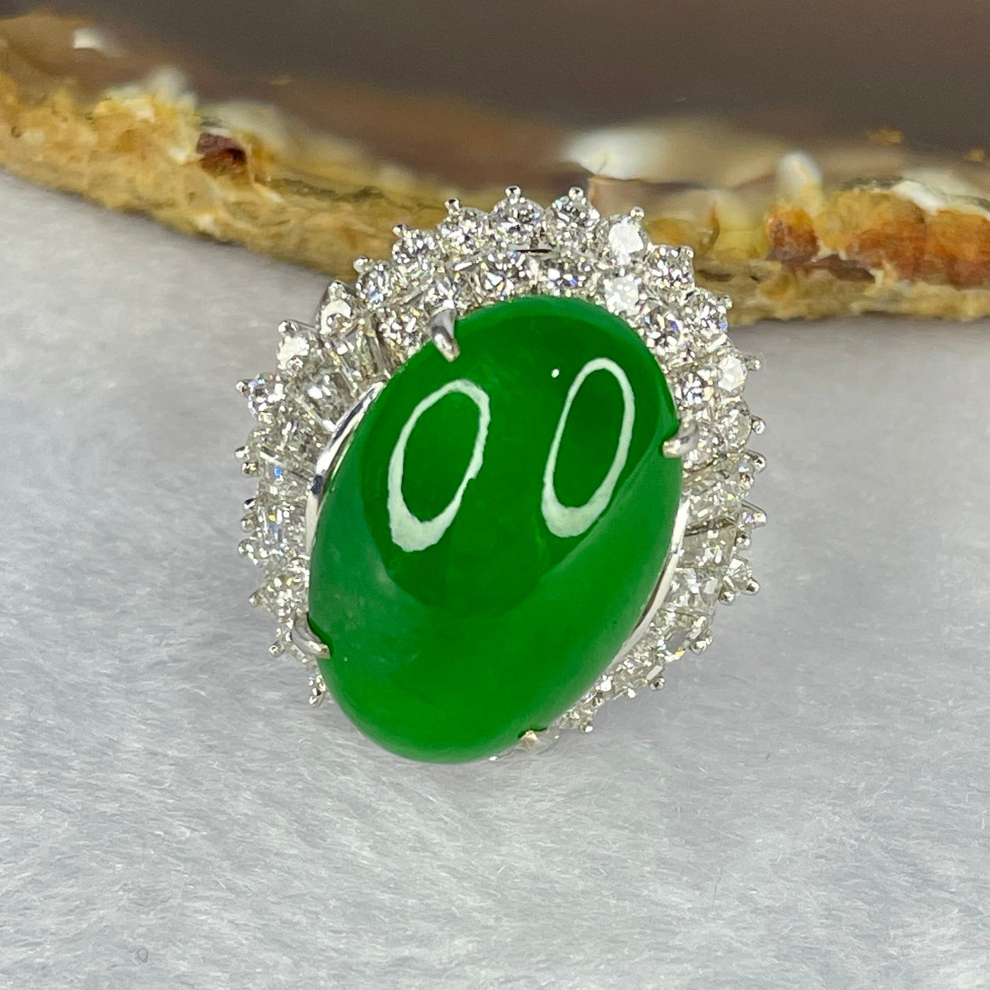 Very Very High Quality Highly Translucent TYPE A Natural Full Intense Green Jadeite Traded as Imperial Green Oval Cabochon Approx. 20.93 by 13.95 by 6.58mm Total Weight 13.60g including Natural Diamonds and 13K White Gold Ring Setting US7.75 HK17 NGI Cert
