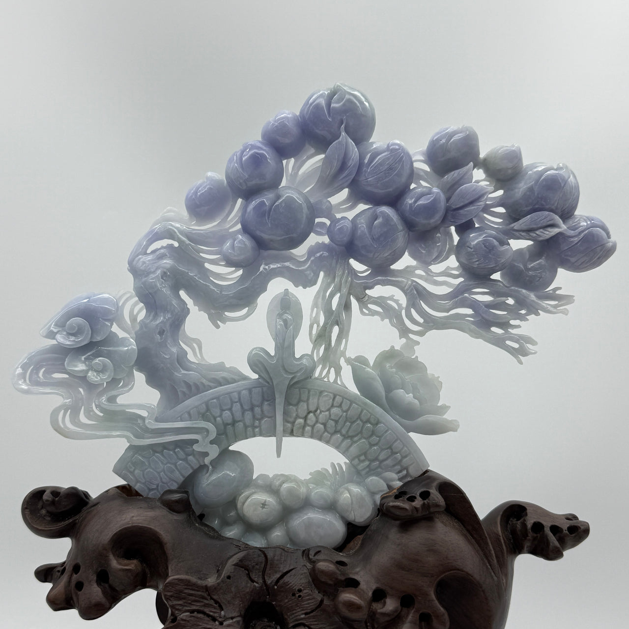 Rare Type A Natural Old Pit Deep Lavender Jadeite Gui Ren with Longevity Peaches and Lotus 470.0g 23.0 by 19.0 by 1.36cm with wooden stand 2285g 25.0 by 12.0 by 32.0cm