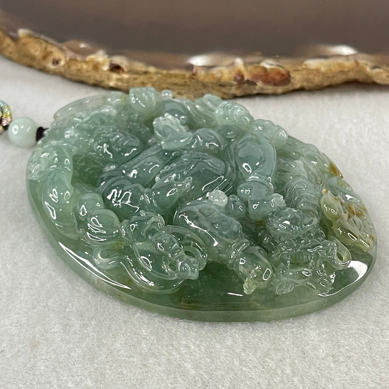 Grand Master Type A Icy Blueish Green with Brown Patches Jadeite Acala Pendant 85.25g 75.0 by 56.6 by 12.4mm